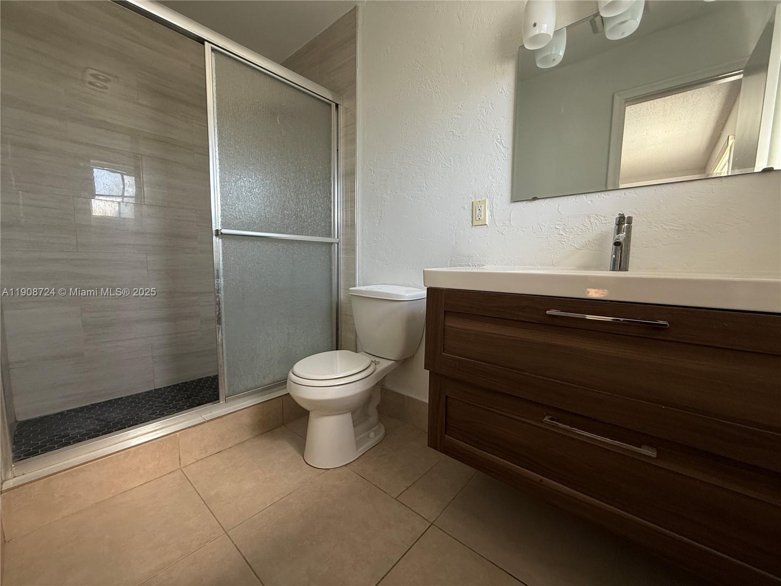 8900 West Sample Road, Unit 204 Coral Springs, FL 33065 - Photo 16 of 21 a bathroom with a toilet a sink and shower