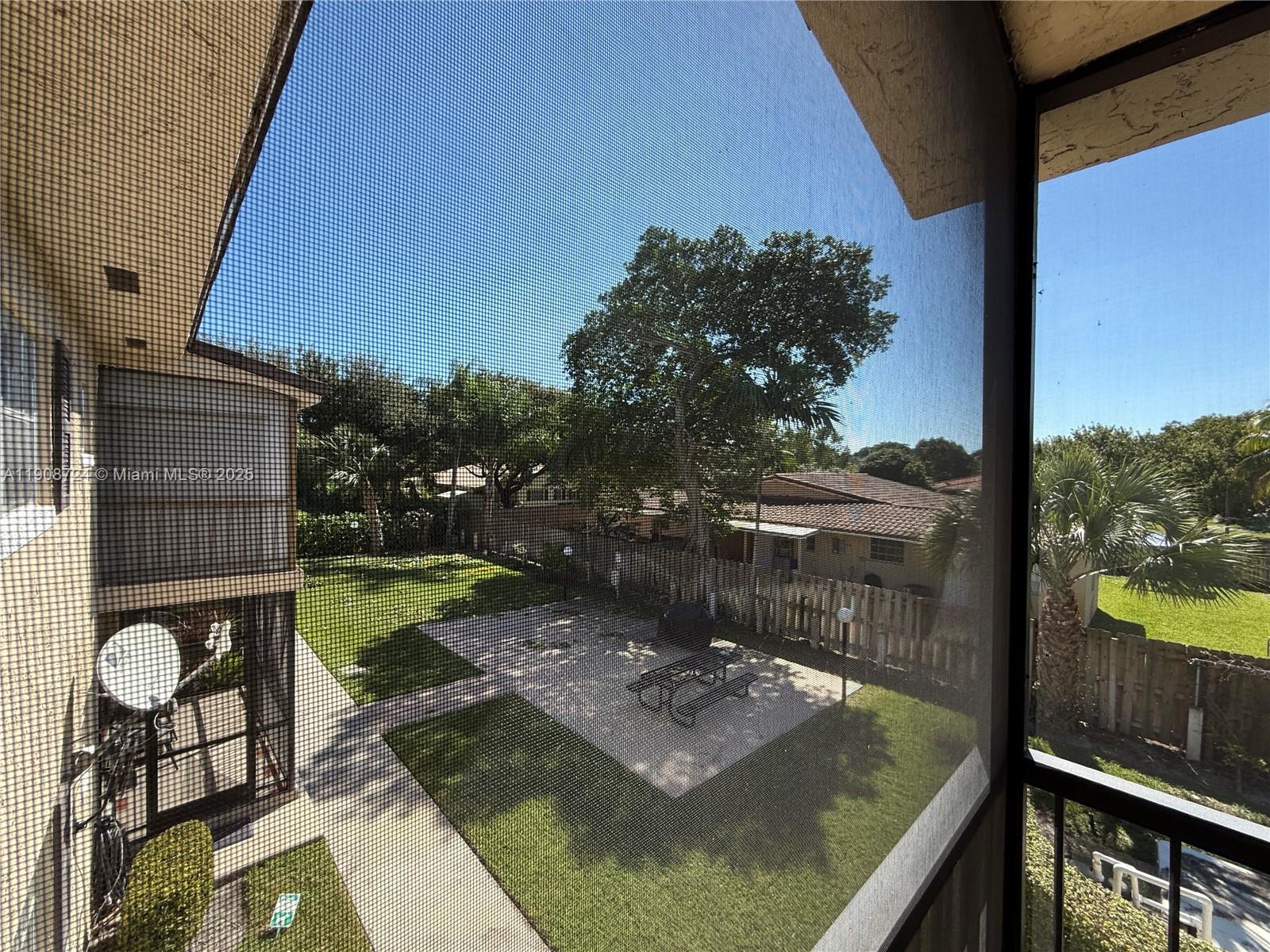 8900 West Sample Road, Unit 204 Coral Springs, FL 33065 - Photo 17 of 21 a view of a balcony with chair and table