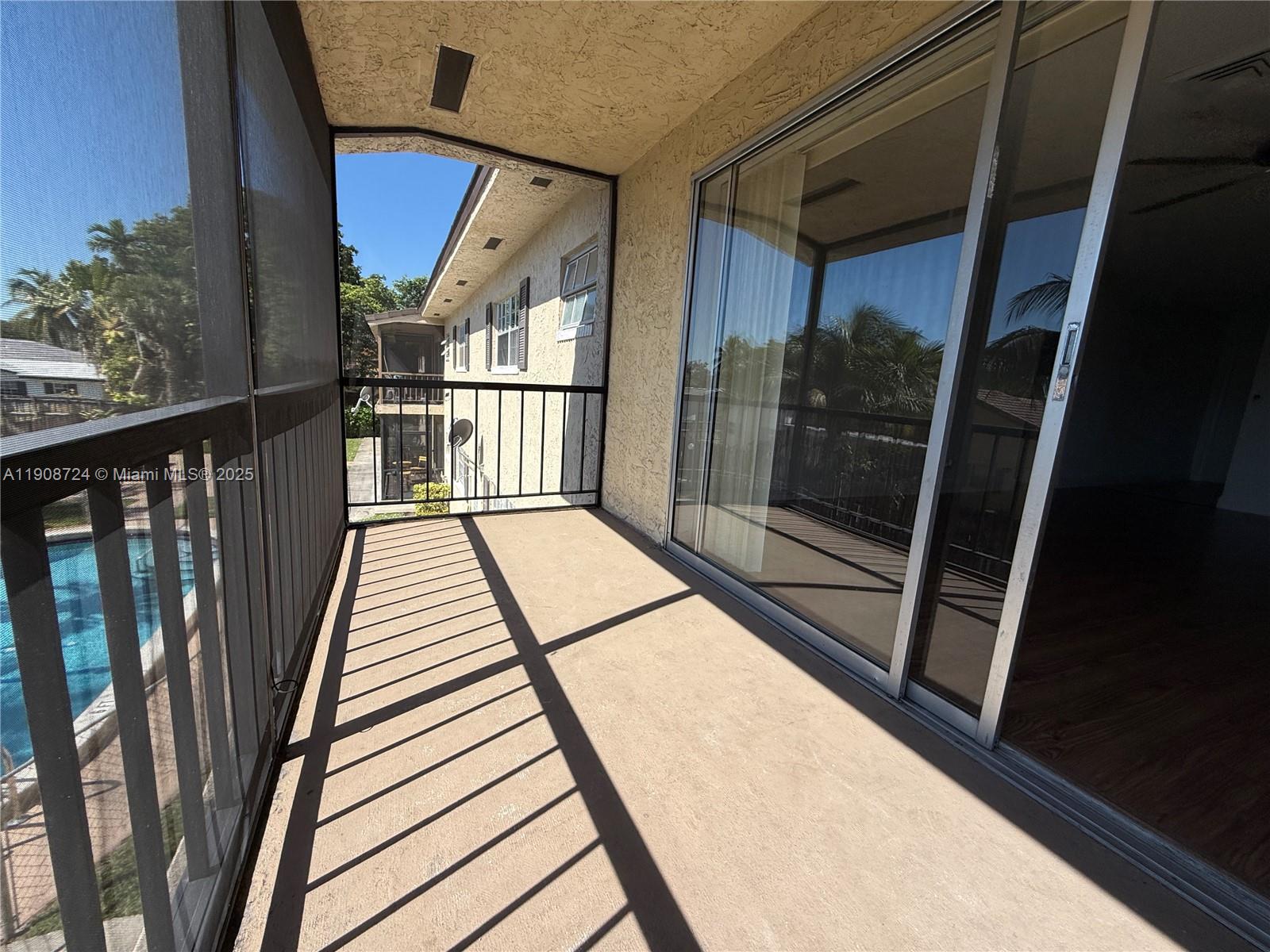 8900 West Sample Road, Unit 204 Coral Springs, FL 33065 - Photo 8 of 21 a view of balcony with a glass door