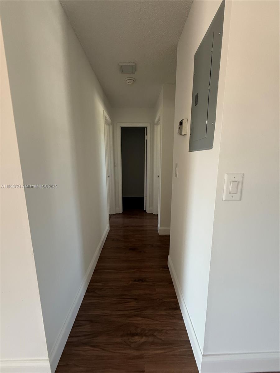 8900 West Sample Road, Unit 204 Coral Springs, FL 33065 - Photo 9 of 21 a view of a hallway with wooden floor and staircase