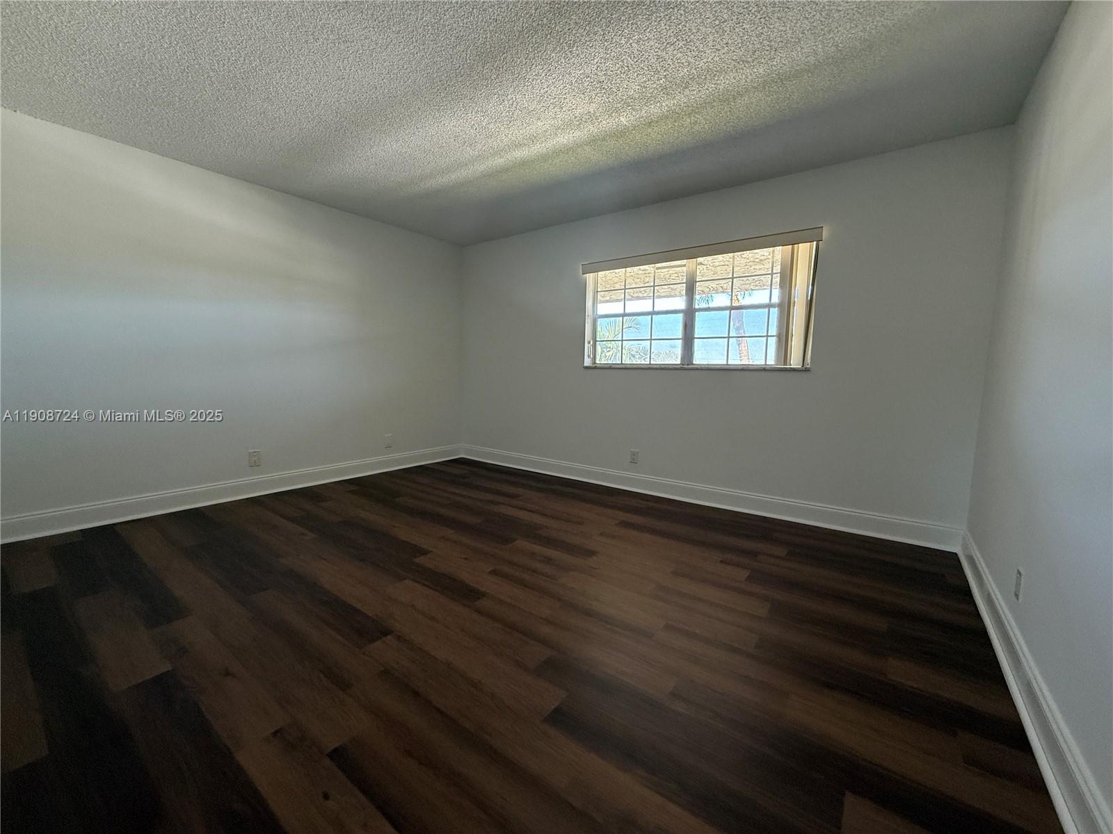 8900 West Sample Road, Unit 204 Coral Springs, FL 33065 - Photo 10 of 21 wooden floor in an empty room