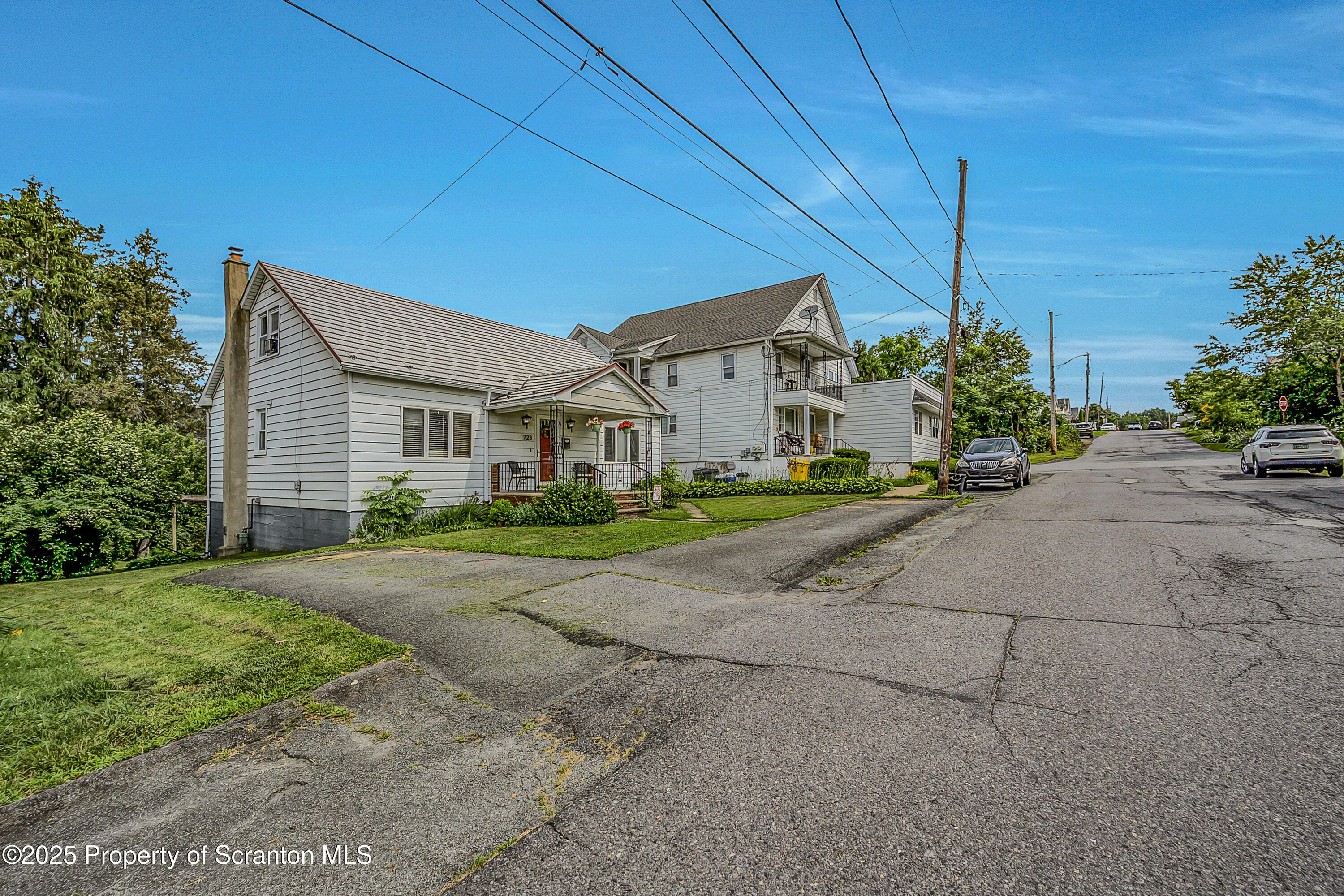 723 Chestnut Street Eynon, PA 18403 - Photo 13 of 34 a front view of a house with a yard and garage