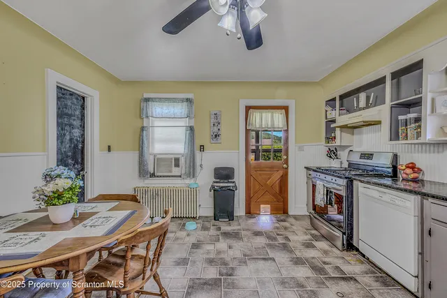 a kitchen with stainless steel appliances granite countertop a stove refrigerator and cabinets
