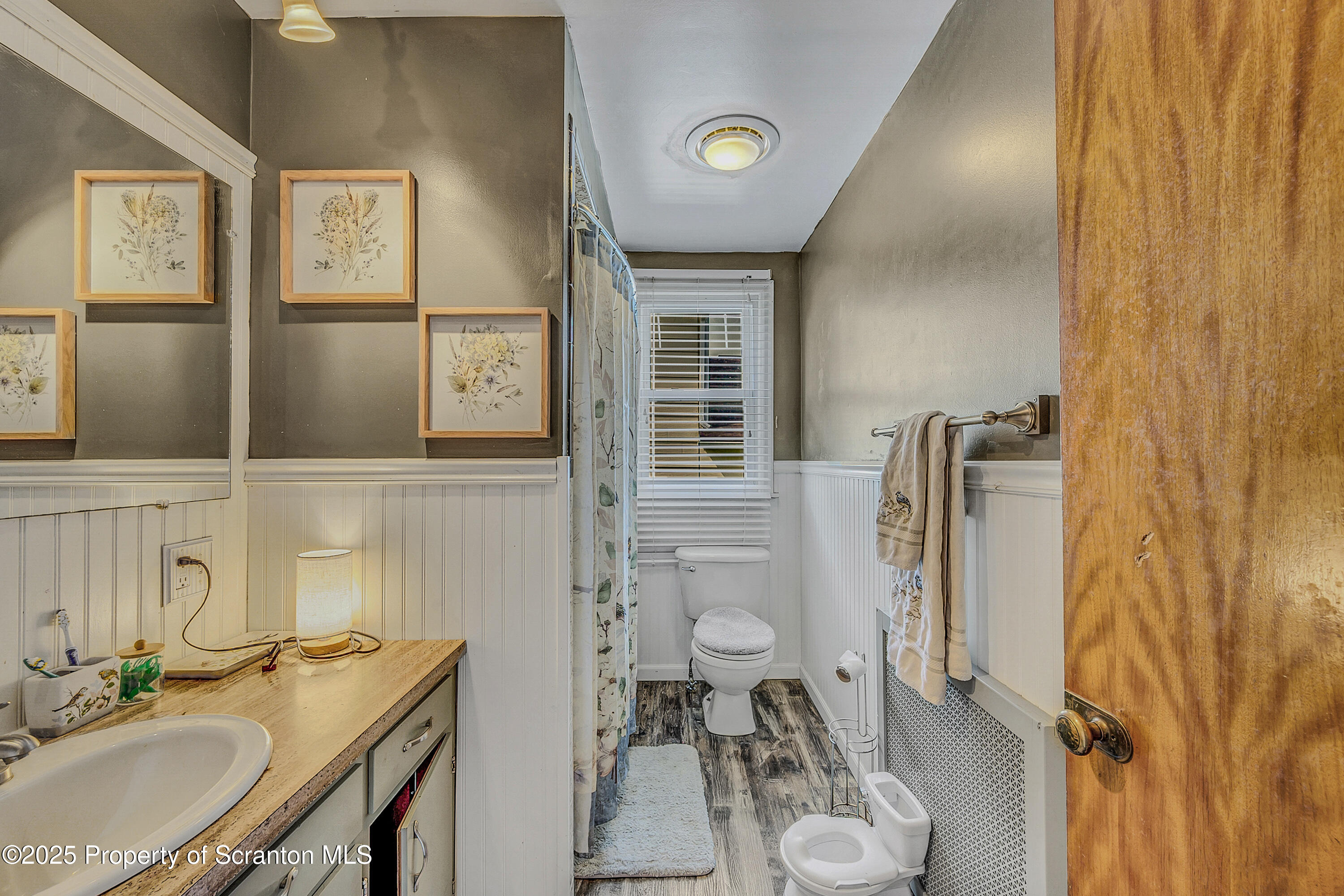 723 Chestnut Street Eynon, PA 18403 - Photo 23 of 34 a bathroom with a granite countertop toilet sink and mirror