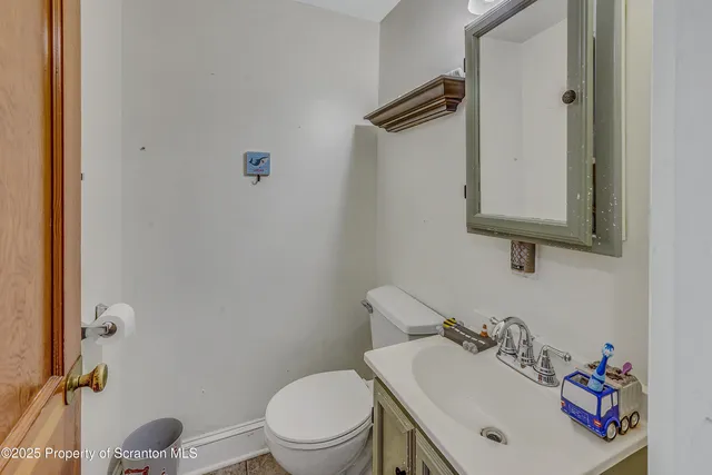 a bathroom with a sink toilet and a mirror