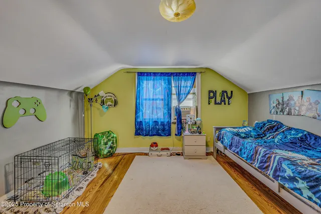 a bedroom with a bed and painting on the wall