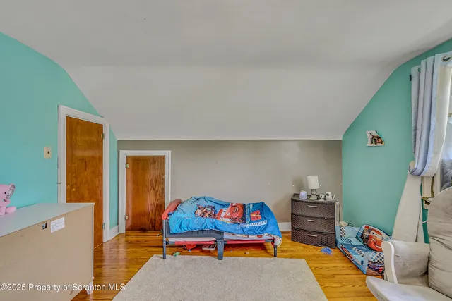 a bedroom with furniture and a window