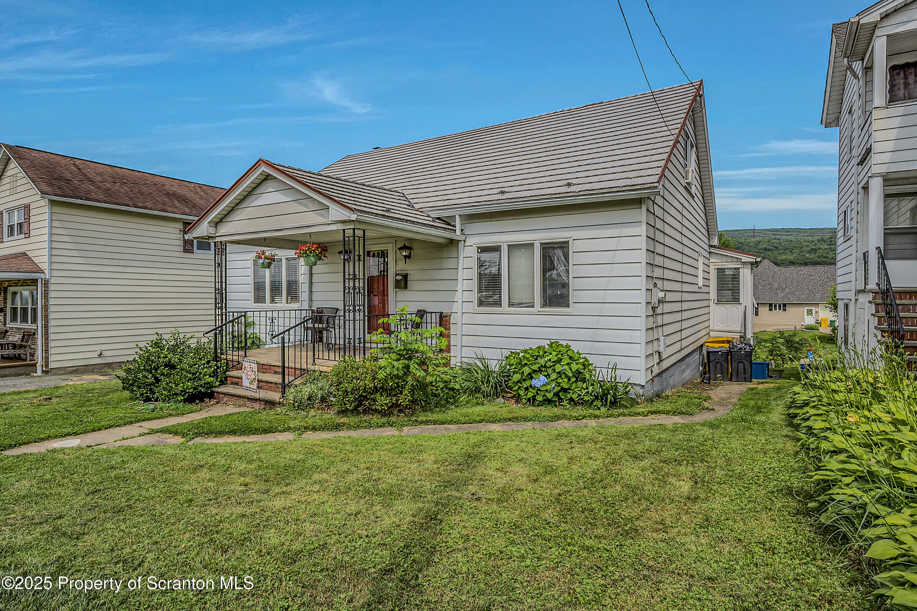 723 Chestnut Street Eynon, PA 18403 - Photo 6 of 34 a front view of a house with a garden