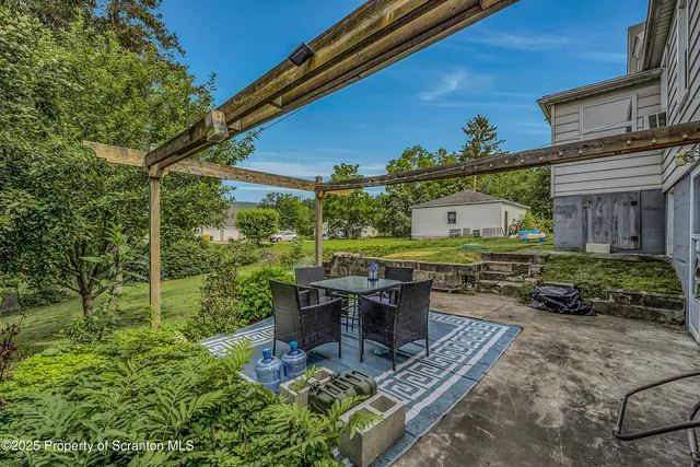 a view of a backyard with sitting area