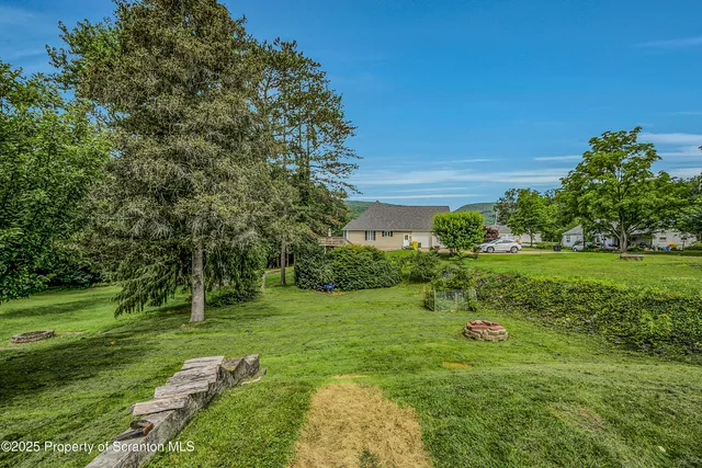 a view of a garden with a building in the background