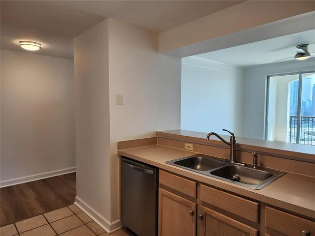 a kitchen with a sink cabinets and a window