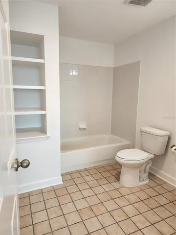 an empty room with wooden floor and closet