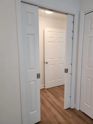 a view of a room with wooden floor