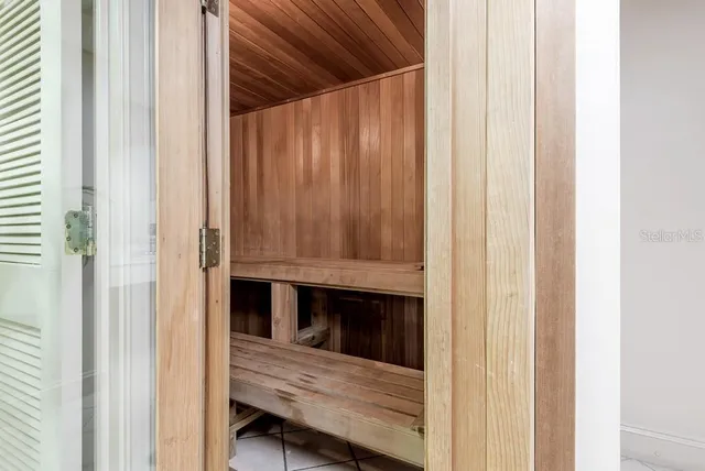 a living room with furniture fireplace and a large window