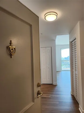 an empty room with wooden floor and mirror