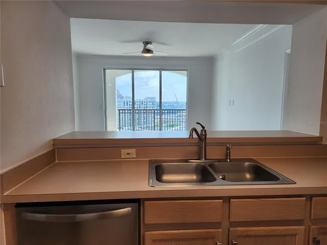 a kitchen with a sink and windows