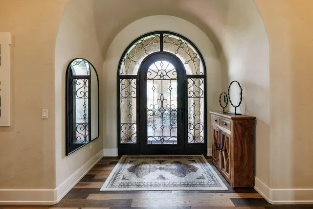 an aerial view of a house with a garden and lake view