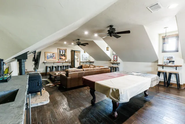 a bathroom with a granite countertop sink a mirror a vanity and shower