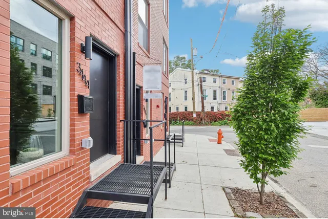 a front view of a building with a garden