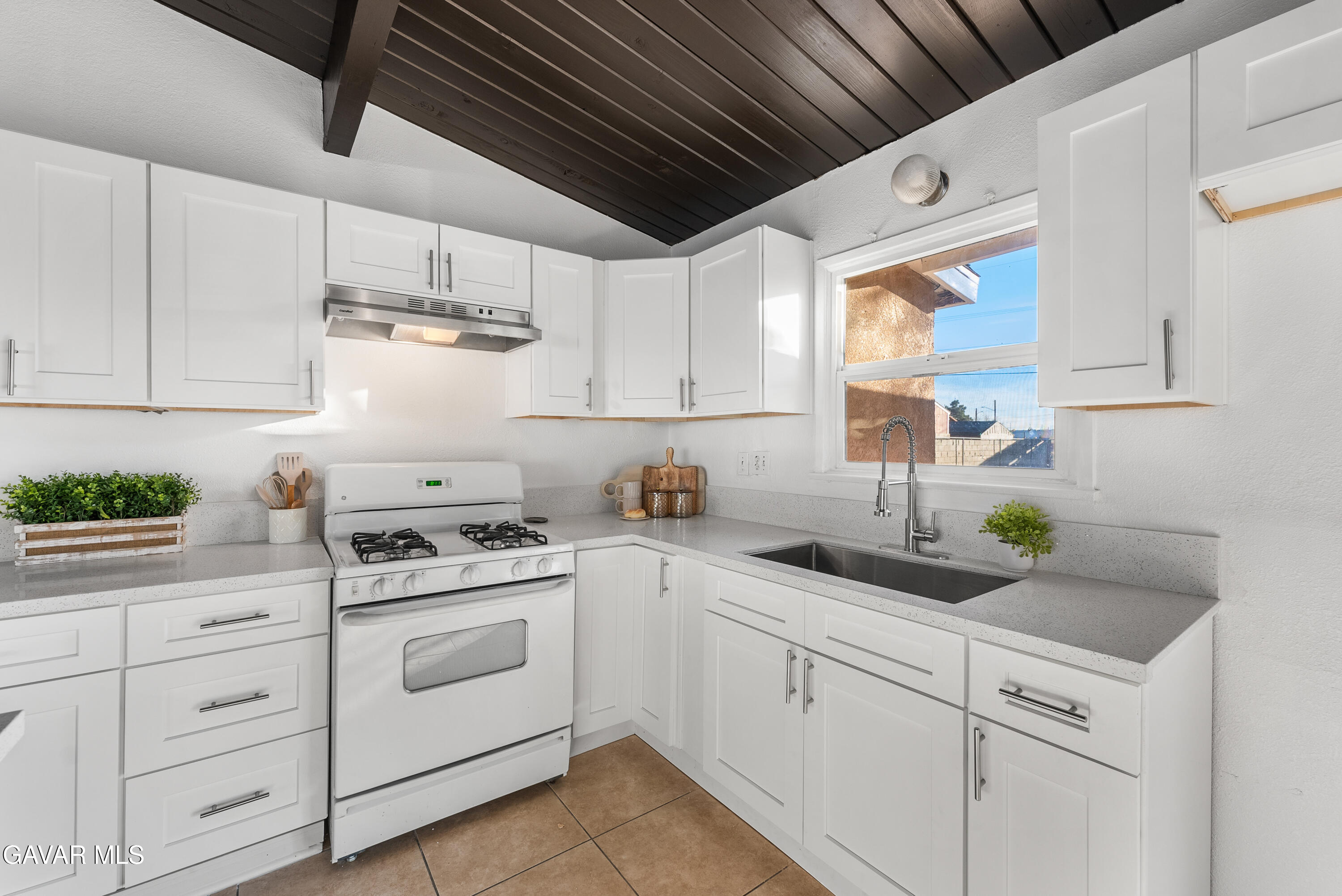 38640 Larkin Avenue Palmdale, CA 93550 - Photo 21 of 38 a kitchen with white cabinets and white appliances