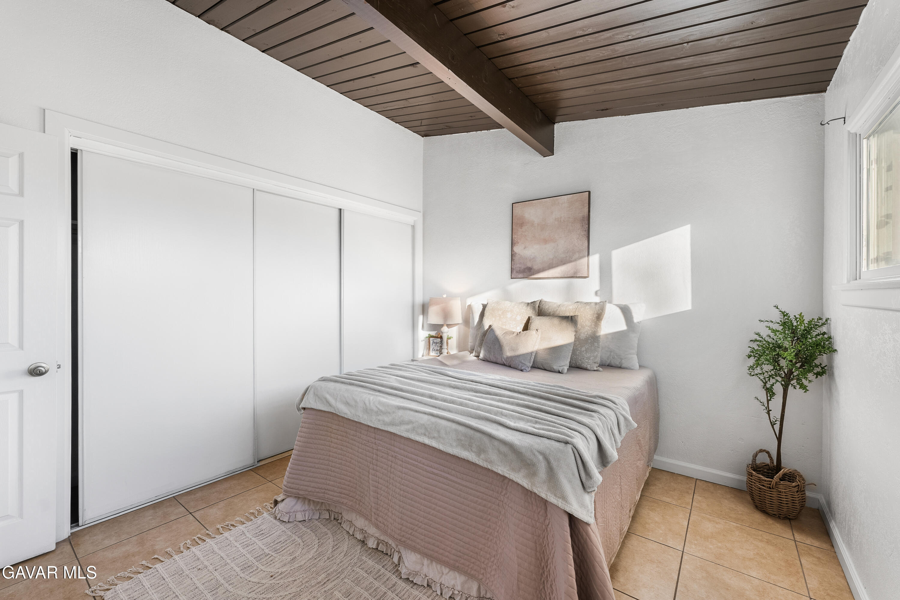 38640 Larkin Avenue Palmdale, CA 93550 - Photo 27 of 38 a bedroom with a bed and a potted plant