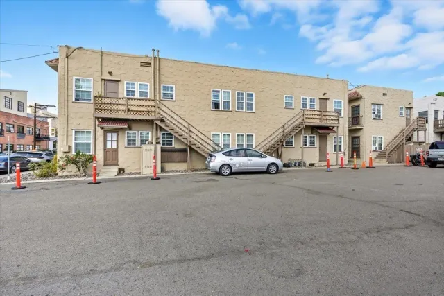 a couple of cars parked in front of a building