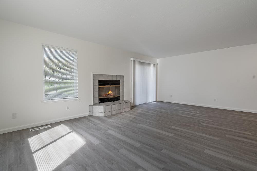 502 Winchester Drive Watsonville, CA 95076 - Photo 14 of 43 a view of empty room with wooden floor and fan