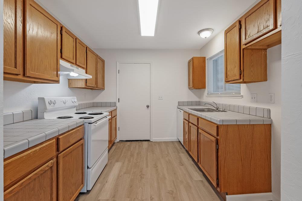 502 Winchester Drive Watsonville, CA 95076 - Photo 16 of 43 a kitchen with stainless steel appliances granite countertop a sink stove and cabinets