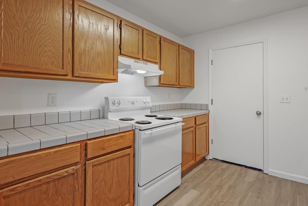 502 Winchester Drive Watsonville, CA 95076 - Photo 17 of 43 a kitchen with stainless steel appliances granite countertop a stove a sink and a white cabinets