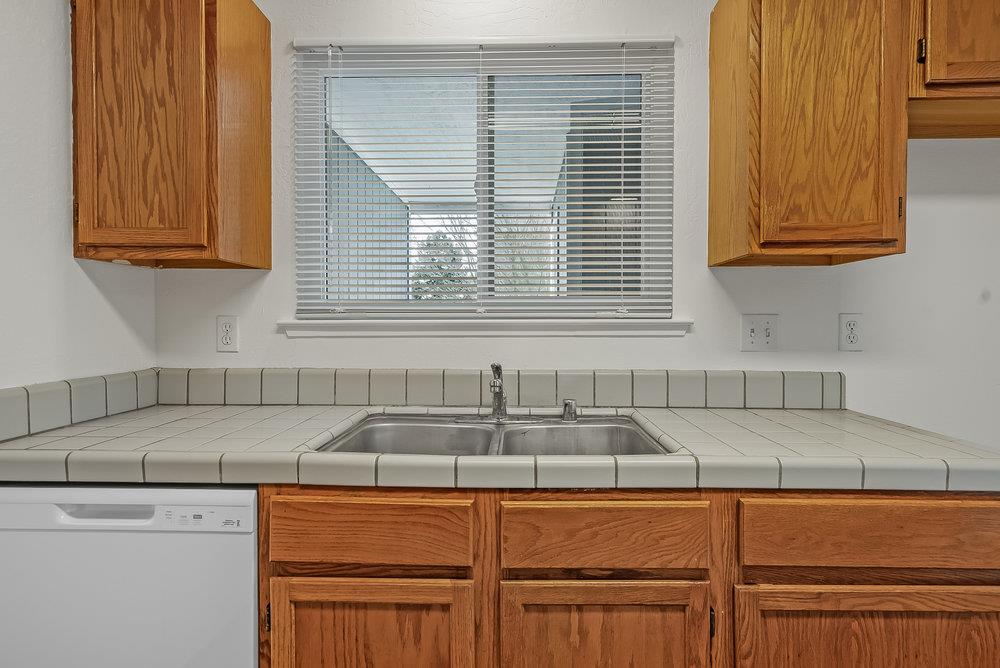 502 Winchester Drive Watsonville, CA 95076 - Photo 18 of 43 a kitchen with stainless steel appliances granite countertop white cabinets and a sink