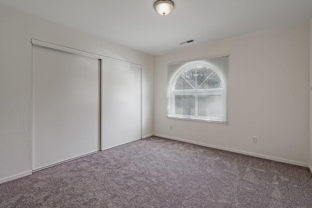 502 Winchester Drive Watsonville, CA 95076 - Photo 23 of 43 an empty room with a window and a fireplace