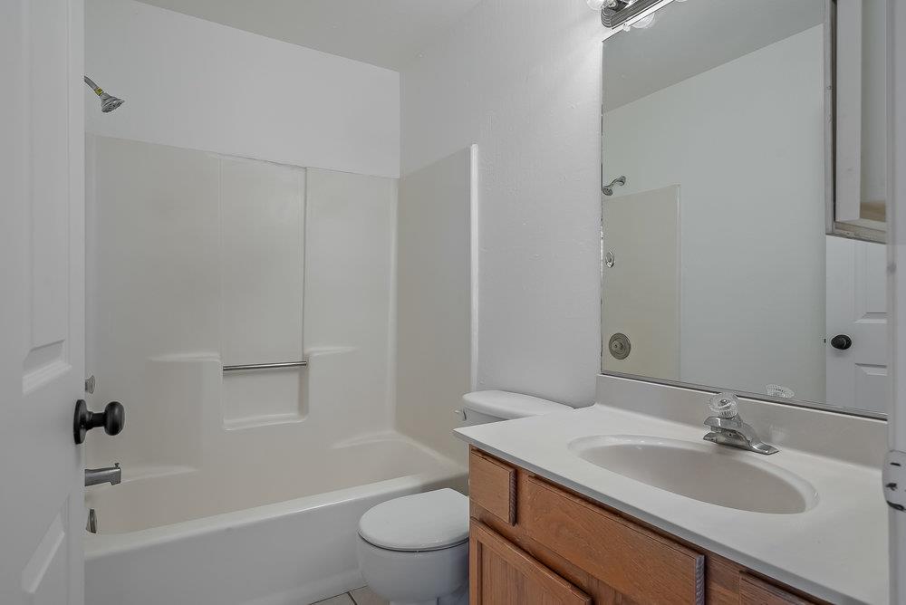 502 Winchester Drive Watsonville, CA 95076 - Photo 35 of 43 a bathroom with a granite countertop sink toilet a mirror and shower