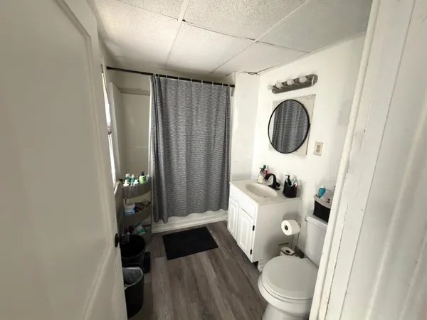 a white toilet sitting next to a bathroom sink and a tub