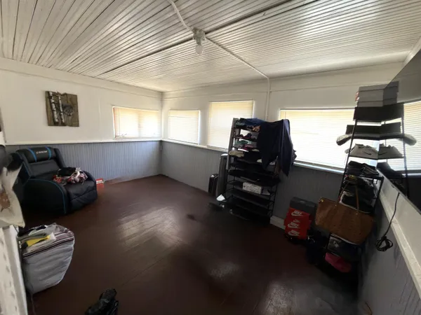 a living room with furniture and hard wood flooring