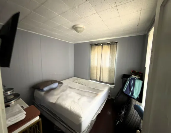 a bedroom with a bed and a window