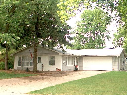 63 Marnel Road Montgomery, IL 60538 - Photo 1 of 1 a house that has a tree in front of it