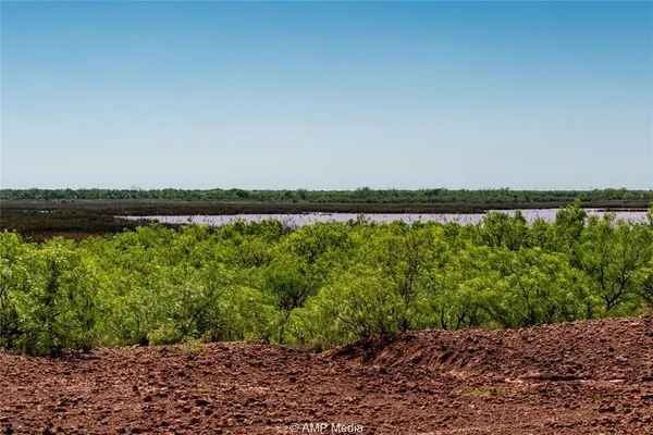 a living room with furniture and a lamp