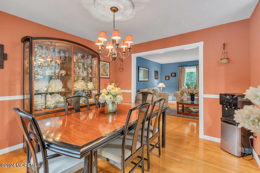 33 Butterfly Road Jackson, NJ 08527 - Photo 11 of 29 a dining room with furniture a chandelier and wooden floor