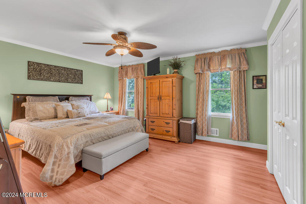 33 Butterfly Road Jackson, NJ 08527 - Photo 12 of 29 a spacious bedroom with a bed and a chandelier