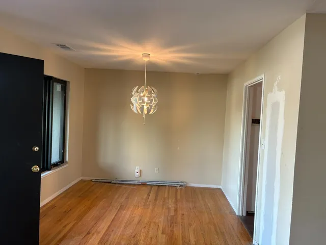 a kitchen with stainless steel appliances granite countertop a stove a sink and white cabinets