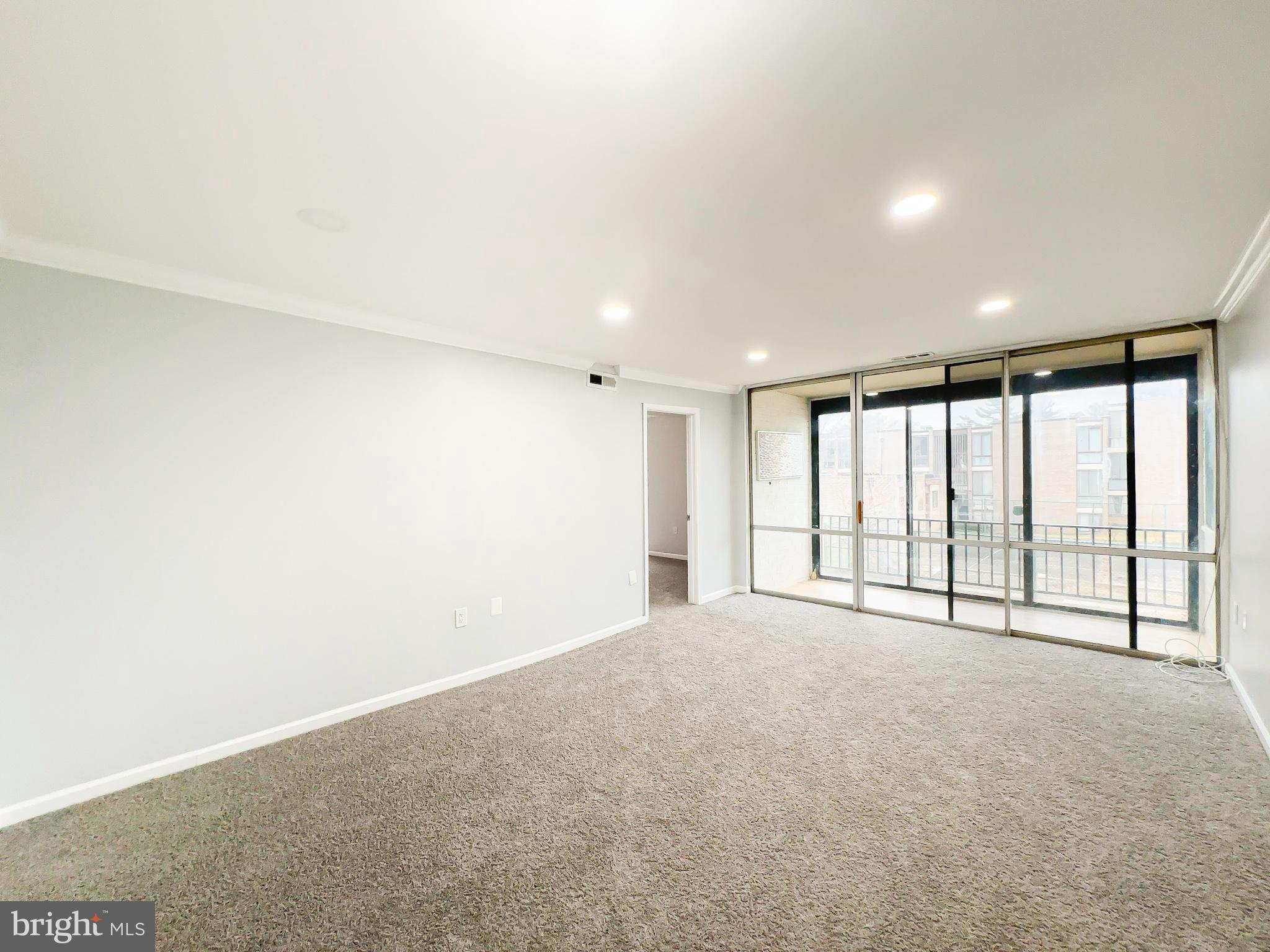 8671 Greenbelt Road, Unit 101 Greenbelt, MD 20770 - Photo 5 of 14 a view of an empty room with a window