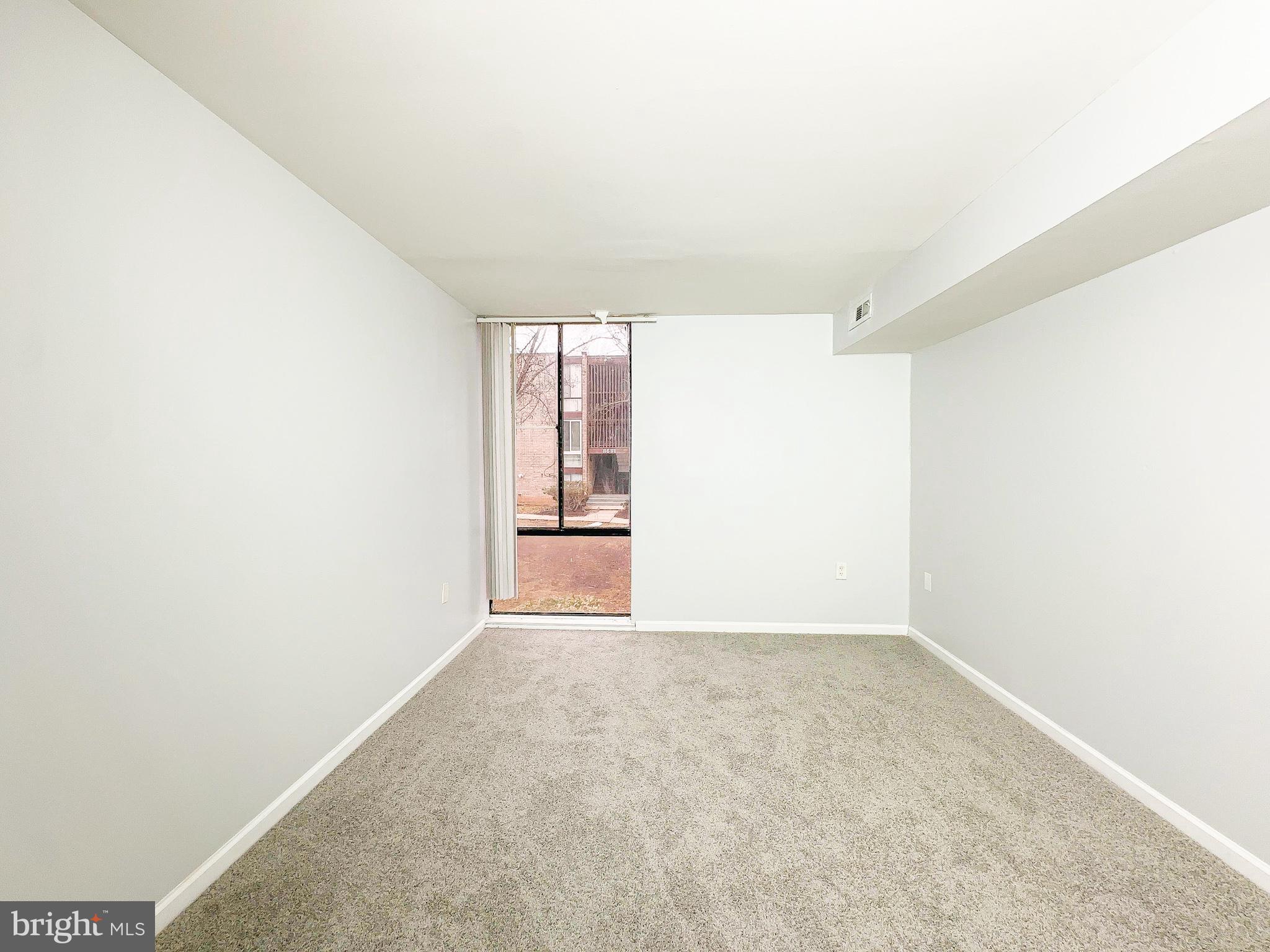 8671 Greenbelt Road, Unit 101 Greenbelt, MD 20770 - Photo 10 of 14 a view of an empty room with a window