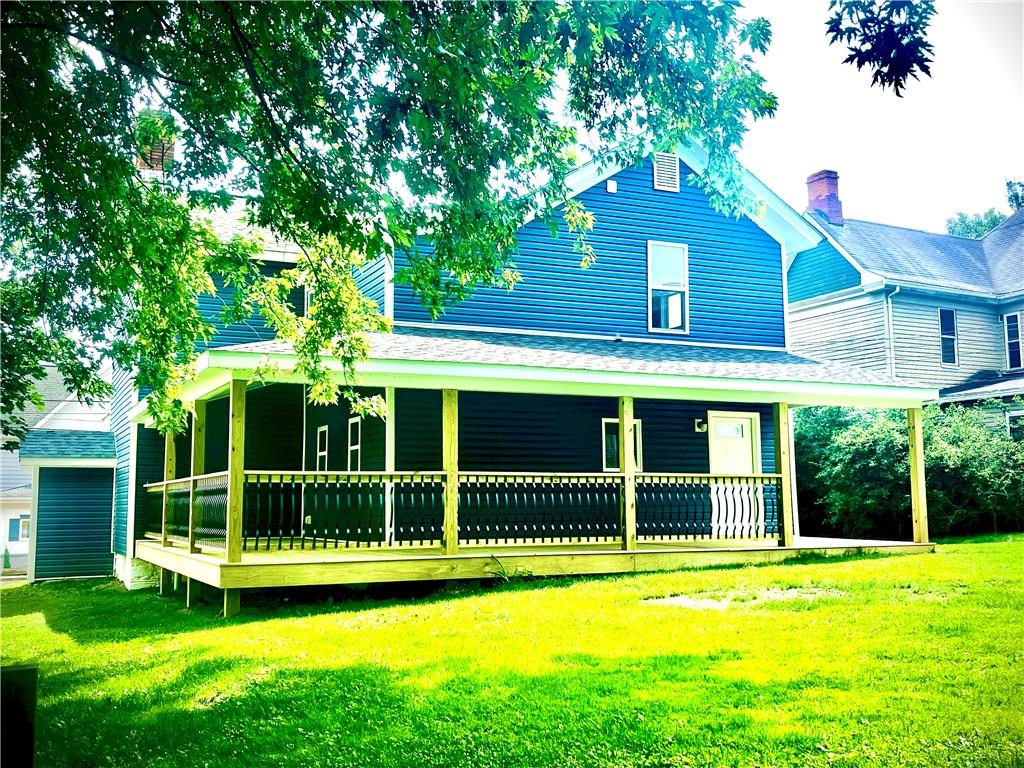 725 West Main Street Rural Valley, PA 16249 - Photo 8 of 35 a view of a house with a yard and a large tree
