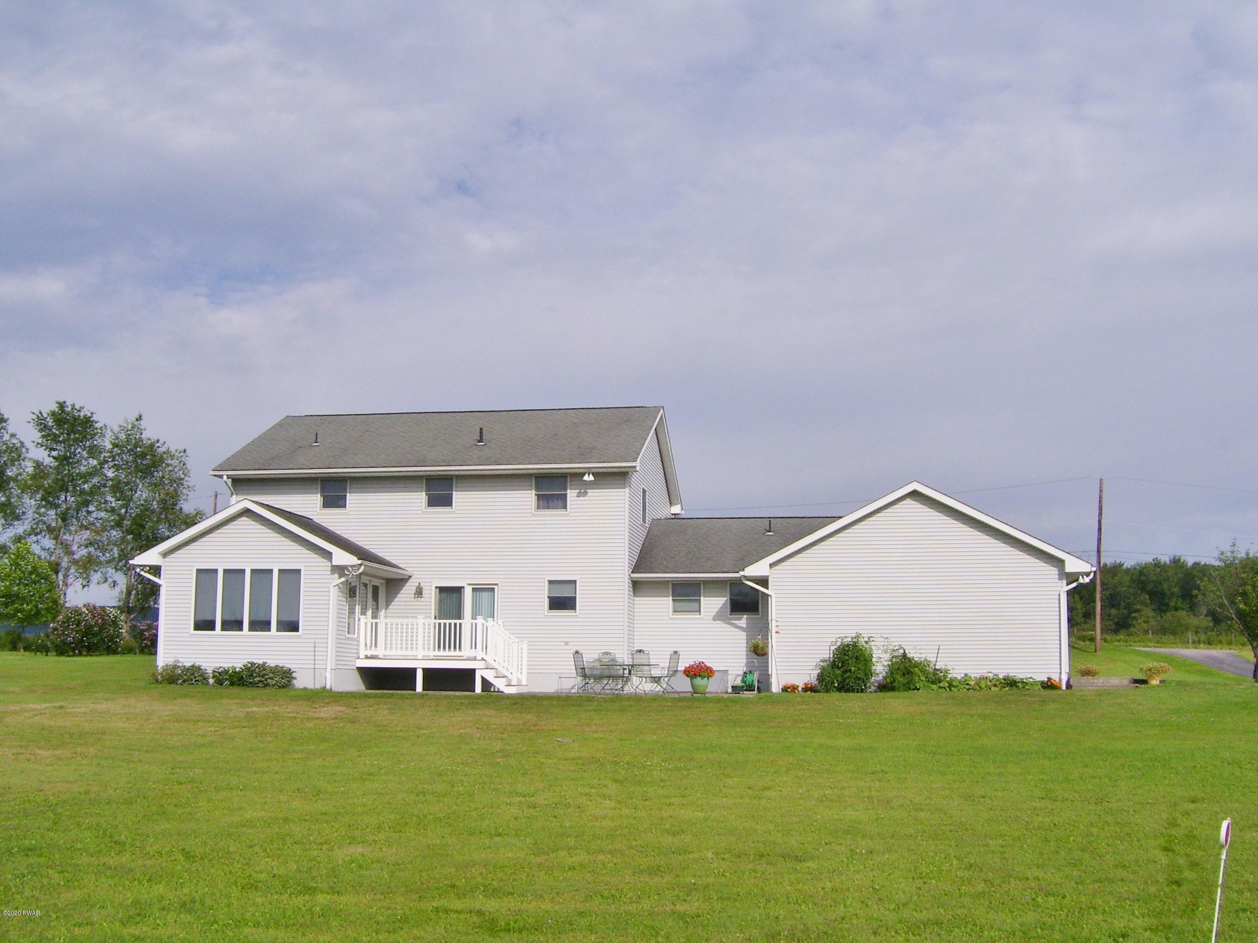 50 Layton Road Waymart, PA 18472 - Photo 50 of 61 a view of a house with a big yard potted plants and large tree
