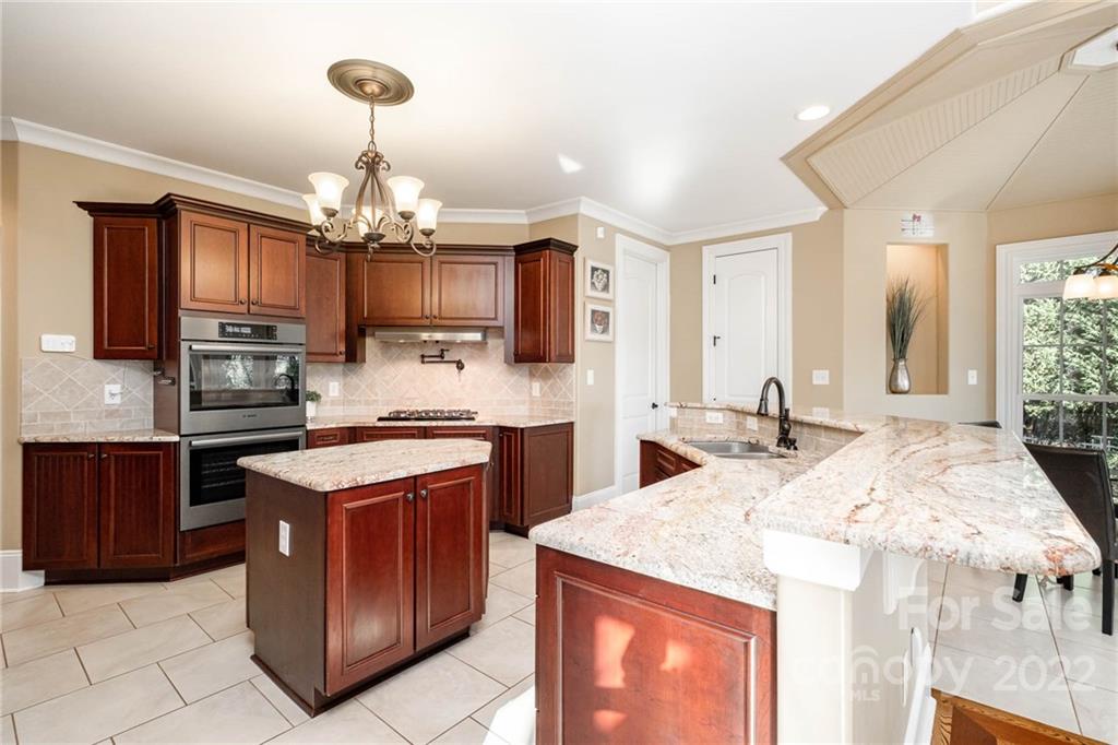 3210 Lake Shore Road South Denver, NC 28037 - Photo 19 of 44 a kitchen with stainless steel appliances granite countertop a sink stove and refrigerator