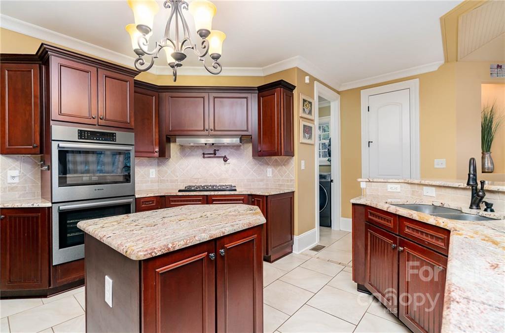 3210 Lake Shore Road South Denver, NC 28037 - Photo 20 of 44 a kitchen with stainless steel appliances granite countertop a sink stove and refrigerator
