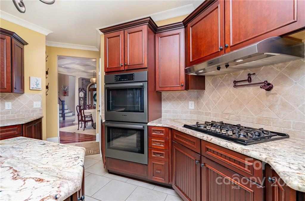 3210 Lake Shore Road South Denver, NC 28037 - Photo 21 of 44 a kitchen with stainless steel appliances granite countertop a stove and cabinets