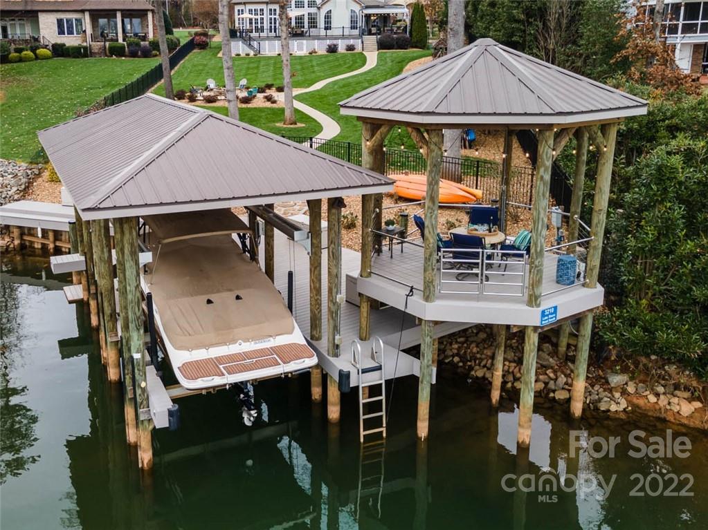 3210 Lake Shore Road South Denver, NC 28037 - Photo 6 of 44 a roof deck with table and chairs under an umbrella