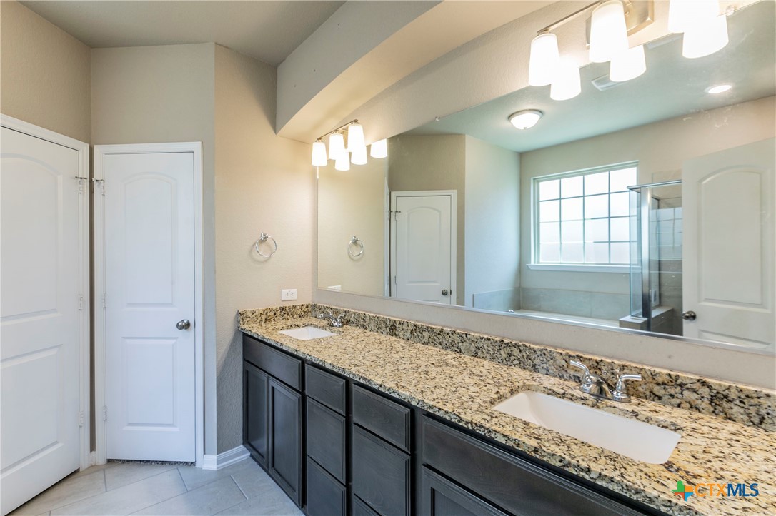 1616 Crooked Tree Temple, TX 76502 - Photo 12 of 22 a bathroom with a granite countertop sink and a mirror