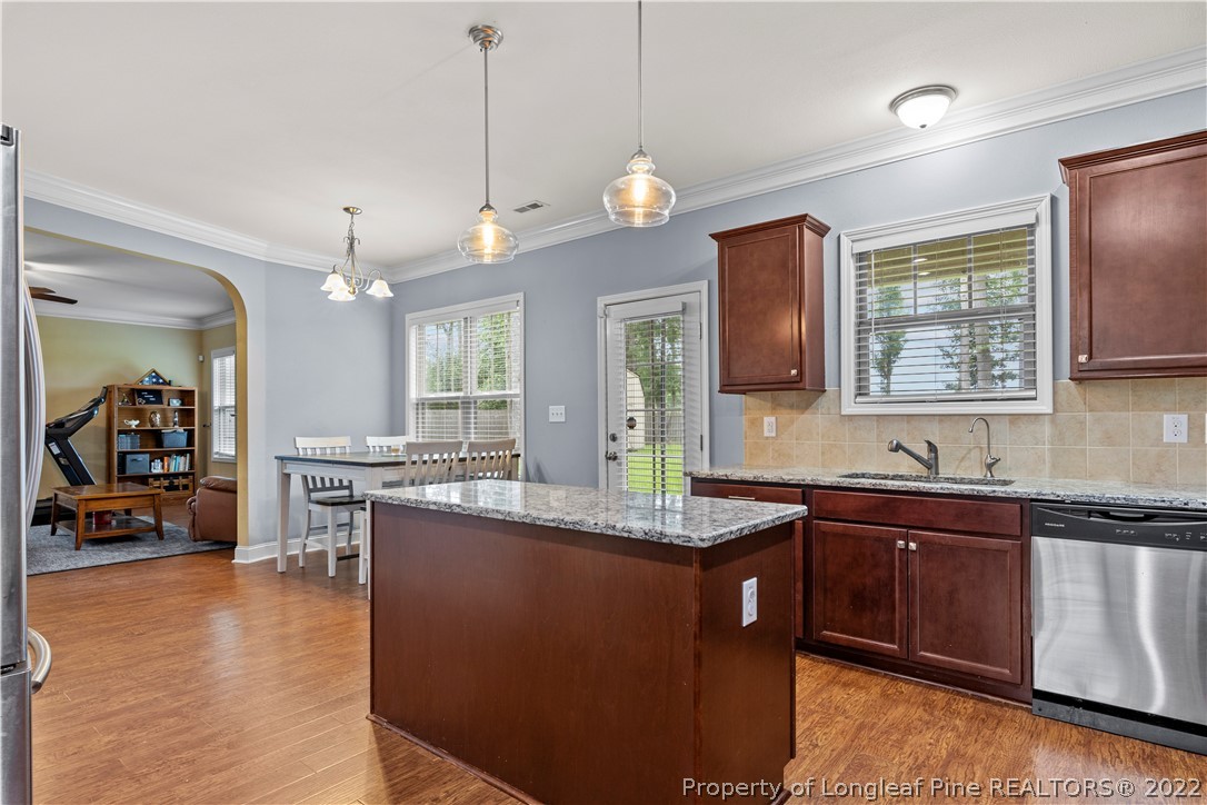 3479 Thrower Road Hope Mills, NC 28348 - Photo 15 of 41 a kitchen with granite countertop a sink a counter space appliances and cabinets